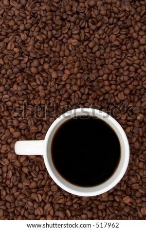 Cup of coffee in a sea of coffee beans