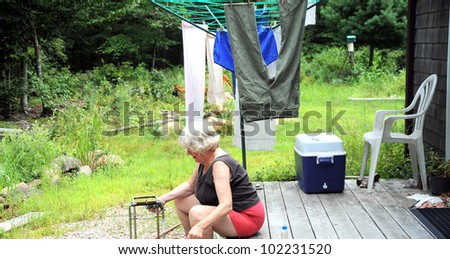 Country woman doing chores outside.