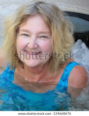 Female beauty enjoying her hot tub at home.