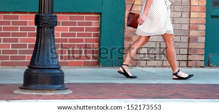 European female shopper walking in the city.
