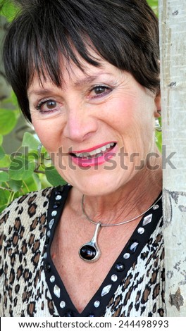 Mature female beauty expressions in the woods outdoors.