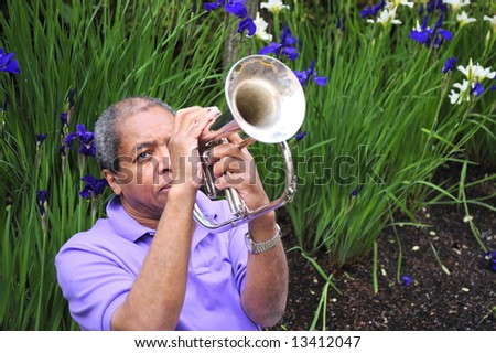 Jazz musician performing in a flower garden on his instrument.