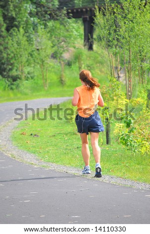 Female jogging on a trail.