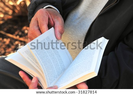 African american male reading a book.