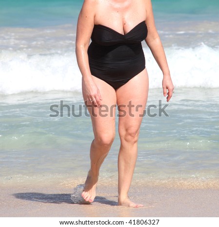Full figure woman enjoying her beach vacation.