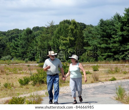 Couple walking on a walking trail outdoors.