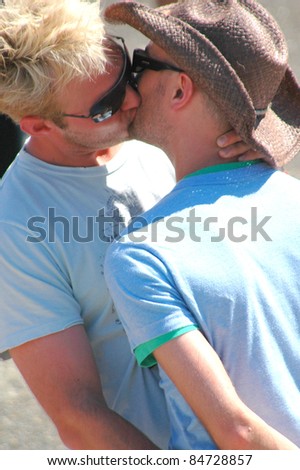 SEATTLE, WA--CIRCA JUNE 25, 2006. People kissing at the Seattle Center circa June 25, 2006.  The Center is hosting the Gay/Lesbian Pride celebration on June 25, 2006