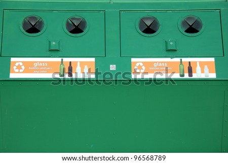 Recycle bin for glass, bottles and jars displayed outside.