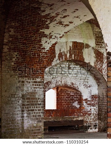Interior room in old brick fort with window looking out.  Suitable for digital background or placing contents in open window.
