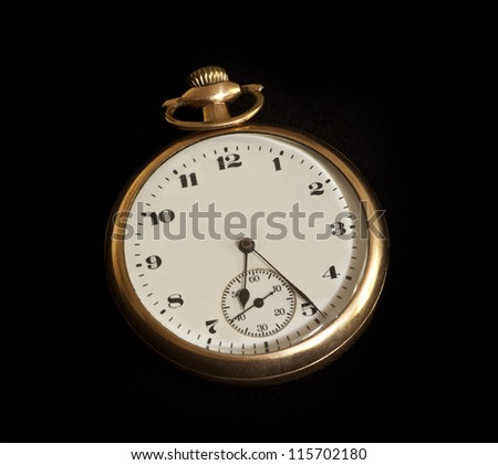 Closeup of one of the most often sold antique gold pocket watches of the 1920s.  Isolated on black.