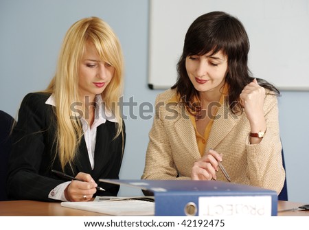 Blonde and brunette women on the meeting in the office