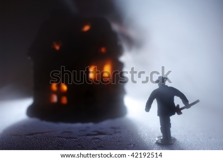 Toy firefighter run onto the burning house