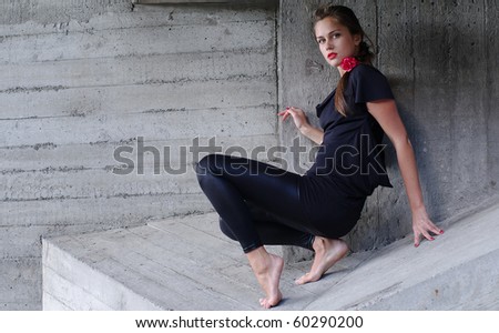 Young woman climbs caught in sharp edges of concrete trap
