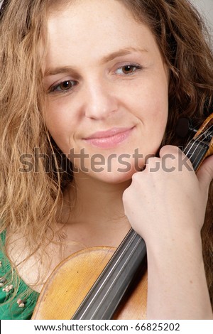 Portrait of sad smiling woman with violin