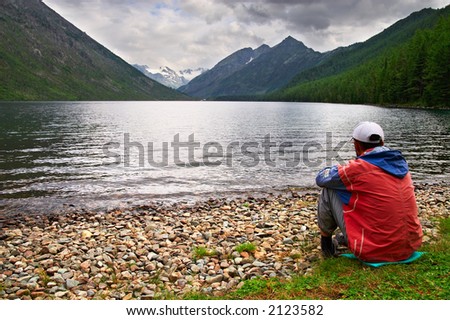 Men, lake and mountains, Altay. Russia.