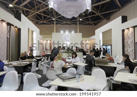 MOSCOW-APRIL 3: Visitors get acquainted with the wallpaper of German manufacturers who sells the company EURO DECOR at the International exhibition Mosbuild on April 3, 2014 in Moscow