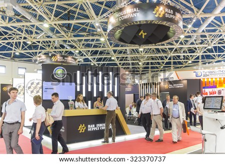MOSCOW-JUNE 24, 2015: Businessmen are in talks at the stand of the American R & B INDUSTRIAL SUPPLY COMPANY STATE OF TEXAS producing oil and gas equipment at the International Trade Fair MIOGE