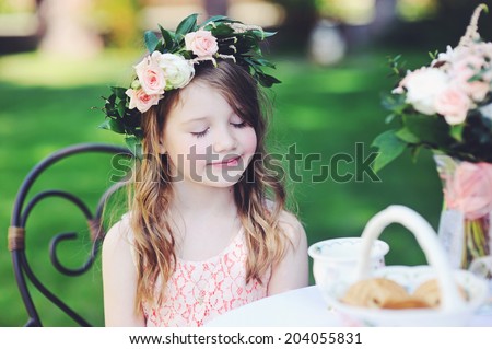 Pretty kid girl with long hair wearing flower wreath