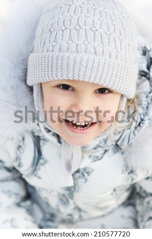 Winter portrait of adorable child girl in winter outfit