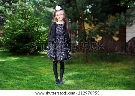 Happy little girl in Halloween outfit having fun in the garden