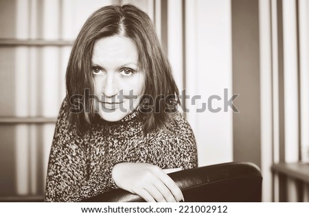Closeup portrait of elegant young  woman indoors in sepia edit