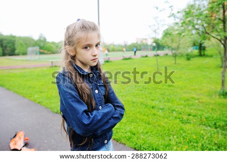 Sad school aged girl on the school yard