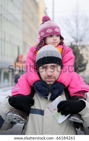 Young father gives his daughter a ride on his back