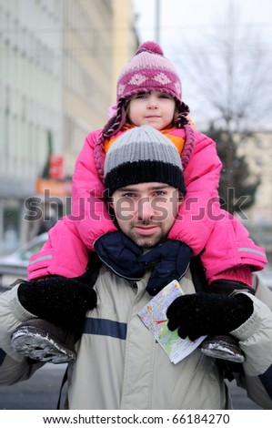 Young father gives his daughter a ride on his back