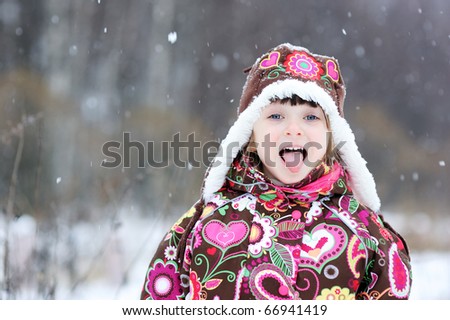 Small girl in colorful snowsiut