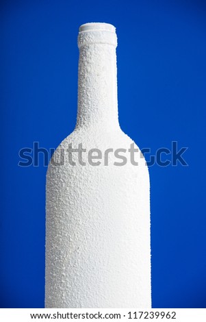 White bottle separated on blue