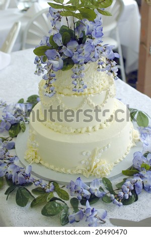 stock photo A photo of a wedding cake with violet colored flowers