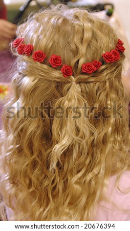 The back of a bridesmaid\'s hairdo for a wedding.