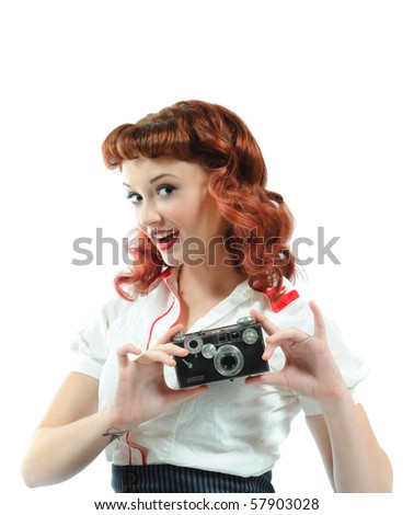 Head shot of a pretty pin-up girl holding a vintage camera.