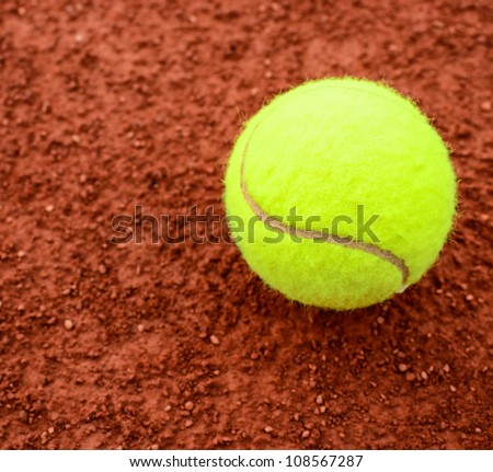 Tennis ball on a tennis clay court