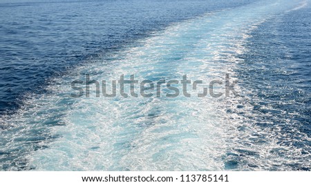 Cruise ship trails in open sea