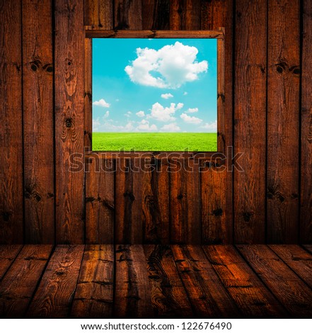 Landscape through window of wooden cottage