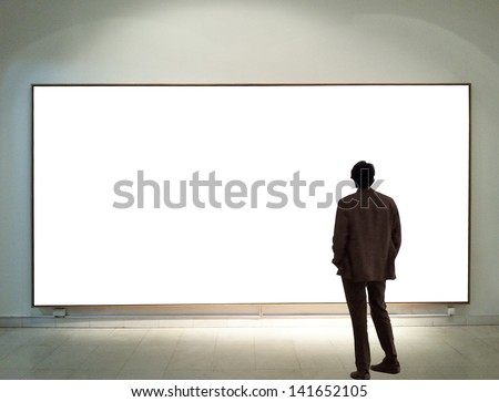 Man In Gallery Room Looking At Empty Frames