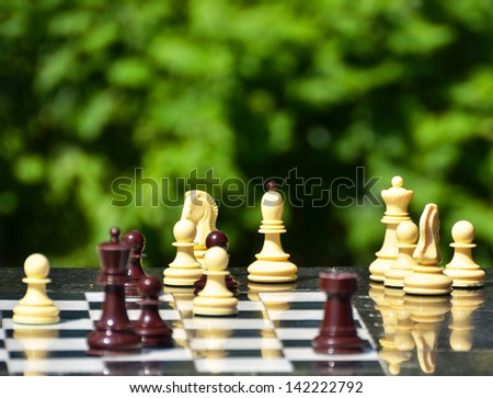 Chess pieces on a table in the park