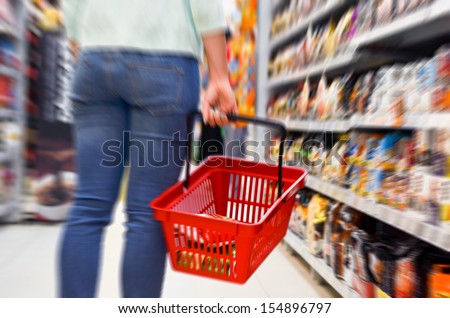 Hand holding empty shopping basket - Shopping concept