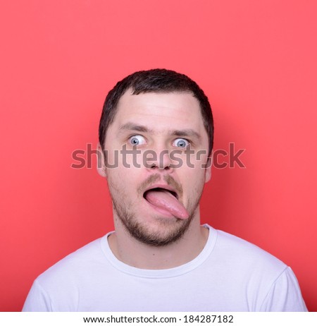 Portrait of girl with funny face against red background