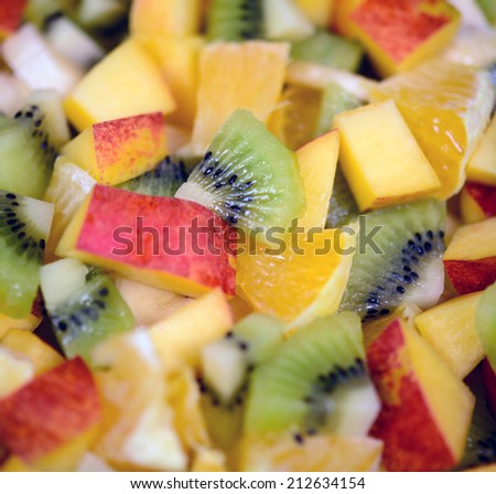 Macro shot of a fresh fruit salad with bananas kiwi orange and peach
