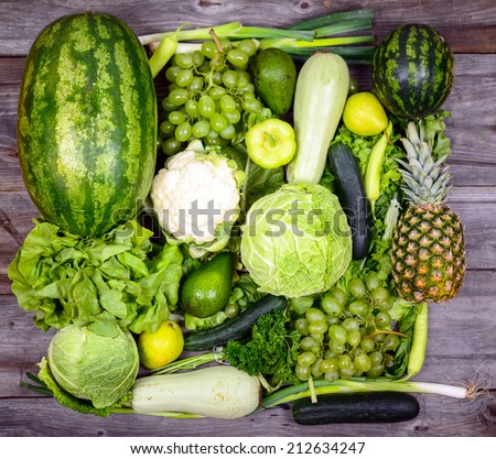 Huge group of fresh green fruit and vegetables on wood background - Concept of healthy green food