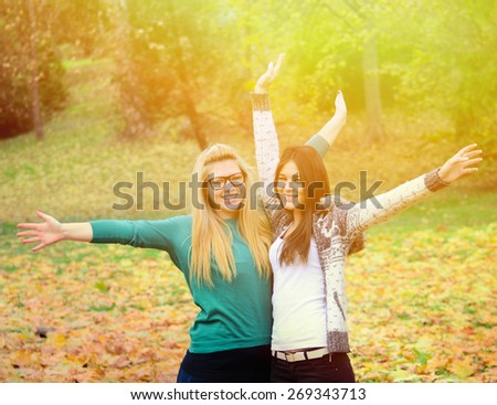 Two happy girl friends in nature