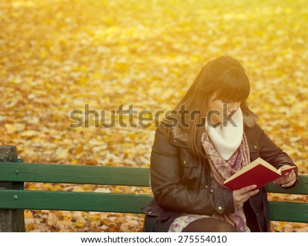 Beautiful young woman reads book