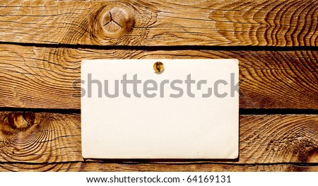 Empty grunge note paper on wood