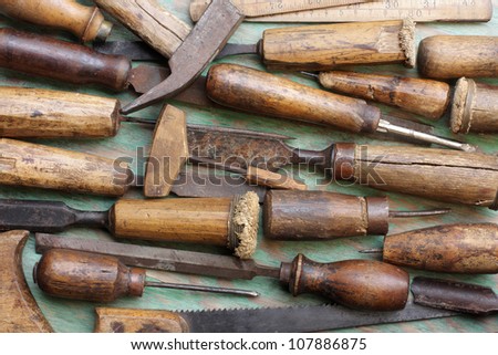Old Woodworking tools arranged on green background