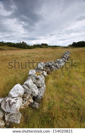 Cultural landscape with stone walls and salt meadows in Norwegian archipelago at Helgeland coast.