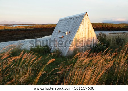 Shelter for eider ducks has a hole for birds, down left. The big door is used by people to fill the seaweed and take out the valuable down. Photo taken et Lanan island in Vega archipelago, Norway.