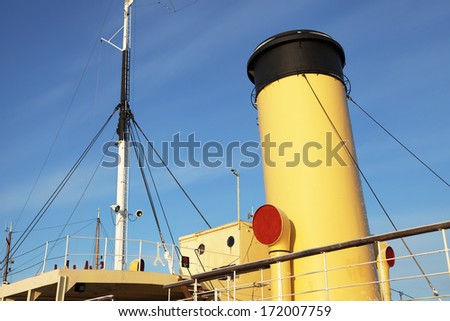 Closeup of a yellow smokestack of an old steam-powered ice breaker from 1914