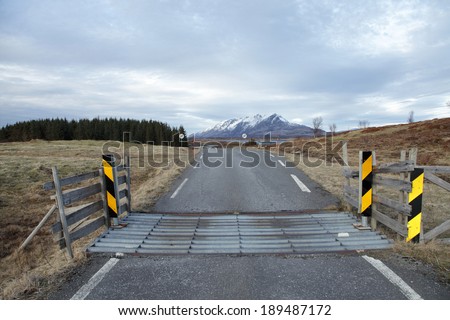 Cattle guard is an alternative to port, keeping free ranging cattle on one side, but allowing cars and people to cross.  Photo is taken in Nordland,  Norway.